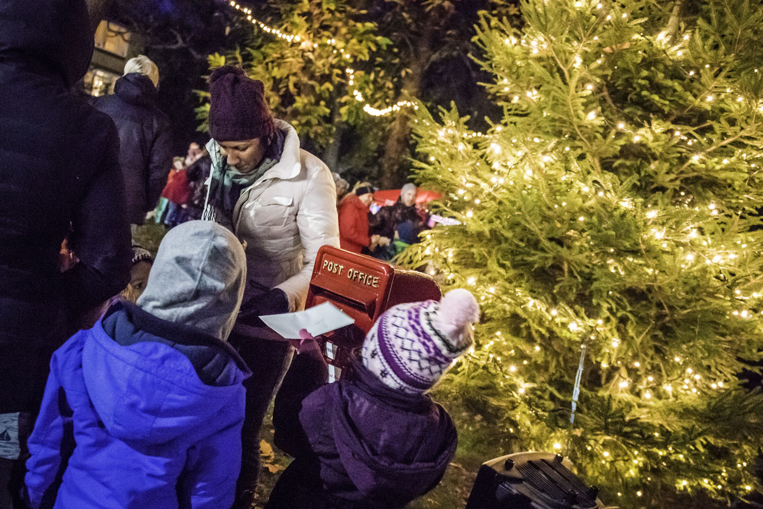 People in front of a christmas tree in Southbourne